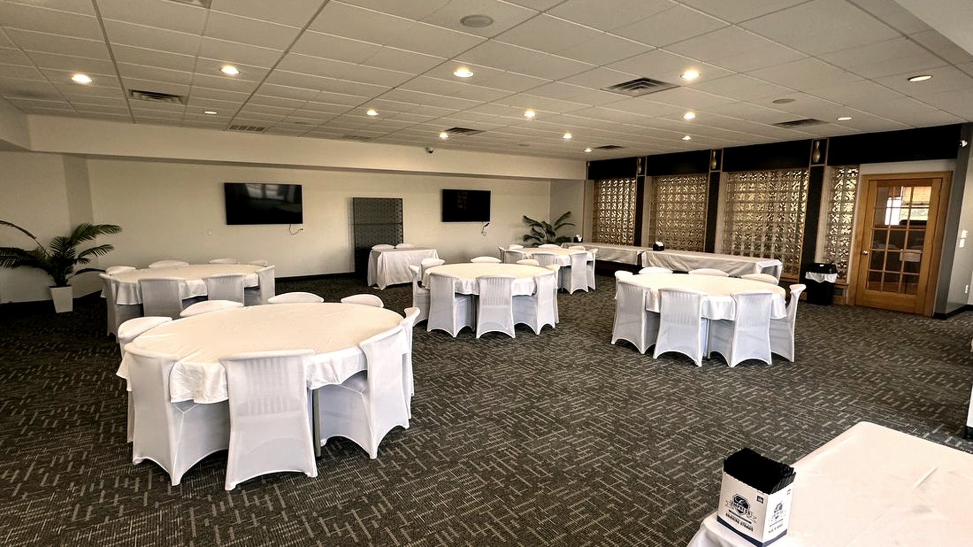 The banquet room at Lakeside Social set with round tables for a private event